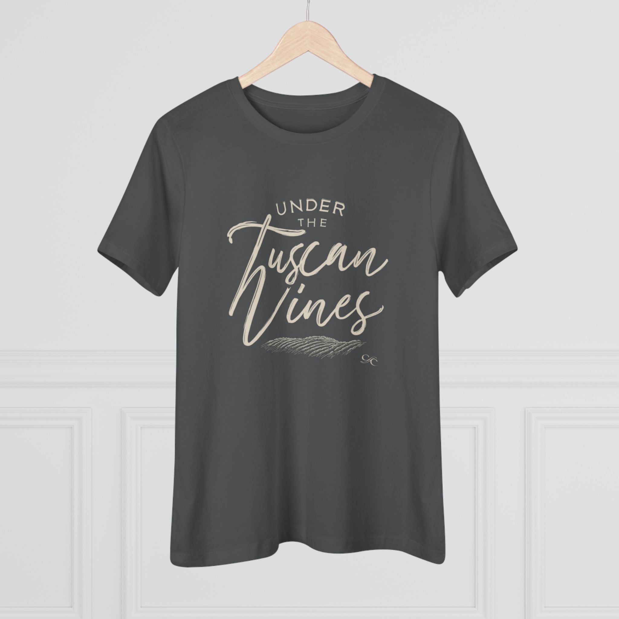Asphalt gray women’s cotton tee with the phrase "Under the Tuscan Vines" in script, displayed on a wooden hanger against a light gray background.